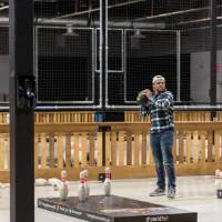 An alumnus getting ready to throw the football at the Fowling Fun Event